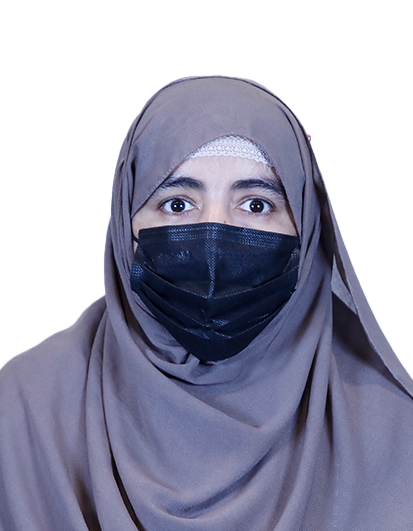 Woman wearing a gray hijab and a black face mask, looking at the camera.